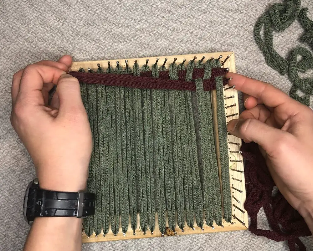 weaving a potholder on a loom